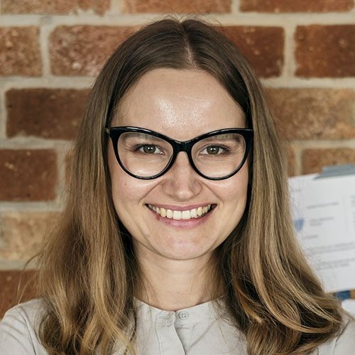 portrait of caucasian woman against brick wall p77rwqd min.jpg